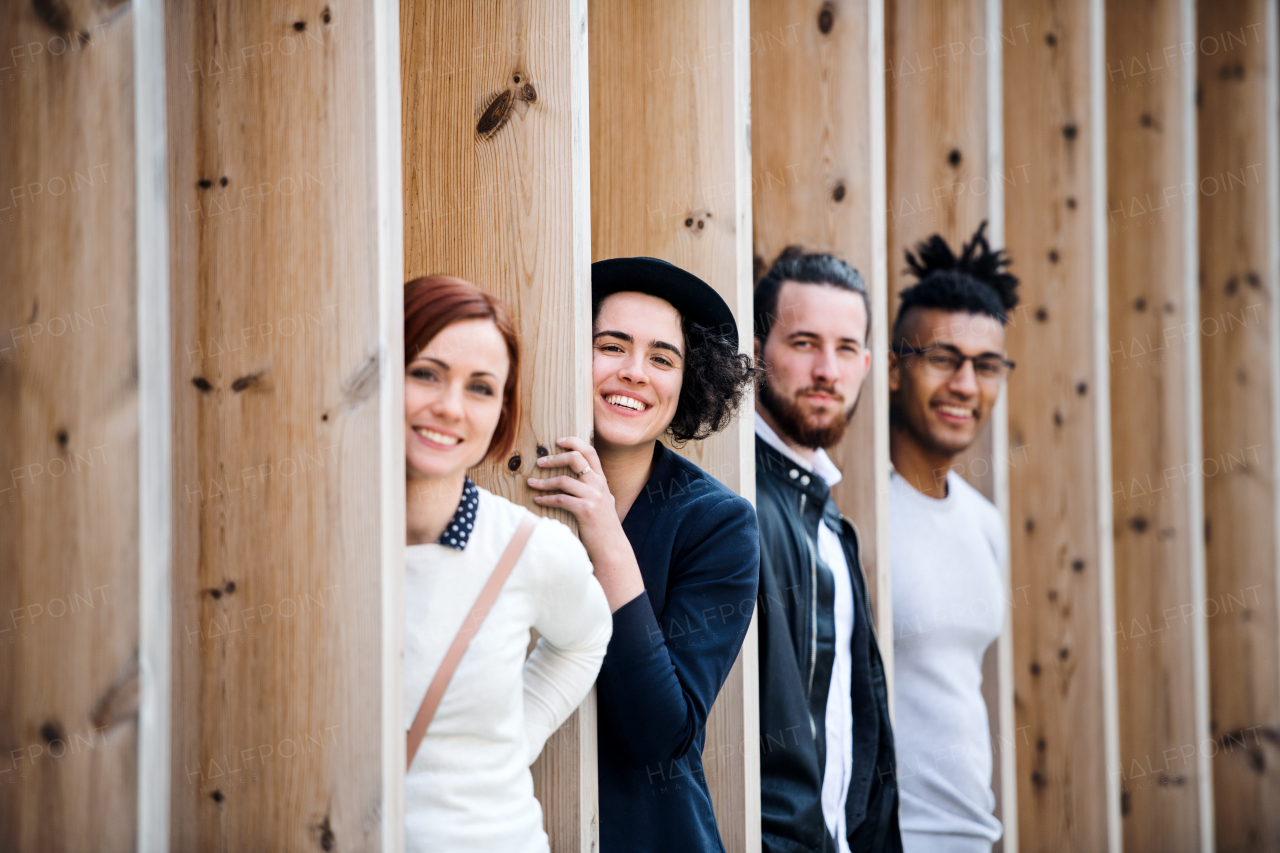 Group of young businesspeople standing outdoors in courtyard, having fun. A start-up concept.