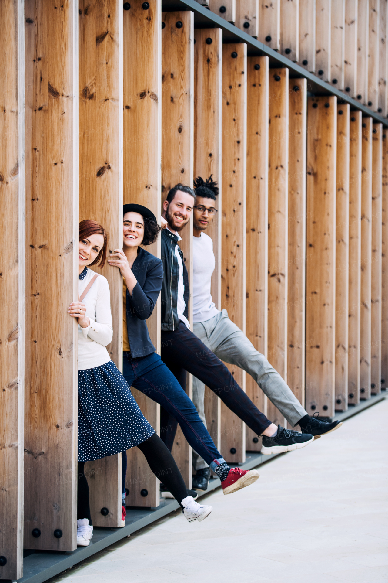 Group of young businesspeople standing outdoors in courtyard, having fun. A start-up concept.