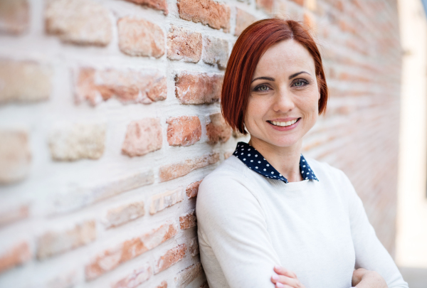 A portrait of young business woman standing outdoors. Copy space. Start-up concept.