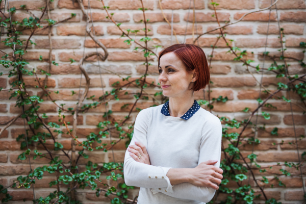 A portrait of young business woman standing outdoors. Copy space. Start-up concept.