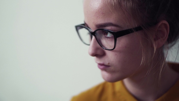 A front view portrait of young sad girl, extreme close-up.