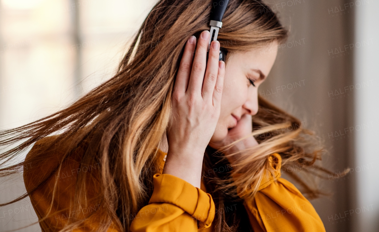 A happy young female student with headphones having fun.