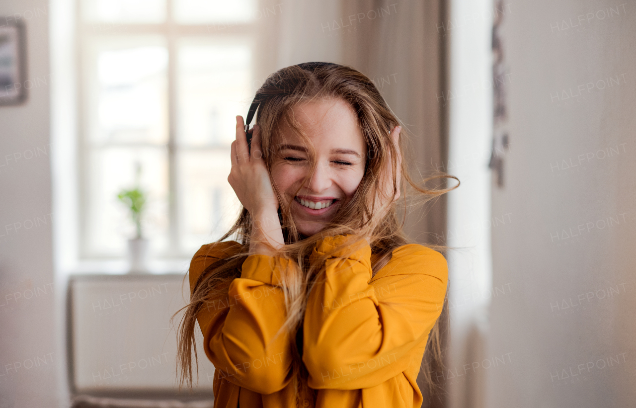 A happy young female student with headphones having fun.