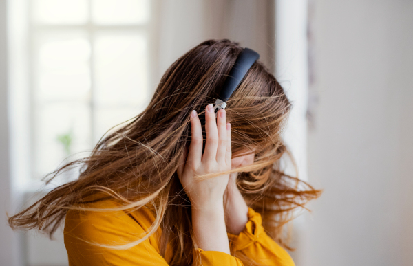 A happy young female student with headphones having fun.