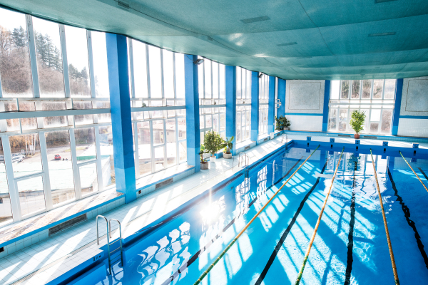 An interior of an indoor public swimming pool. High angle view.