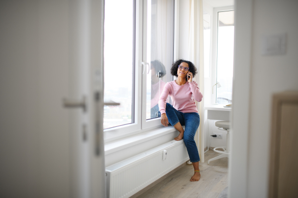 A portrait of happy mature woman making a phone call indoors.