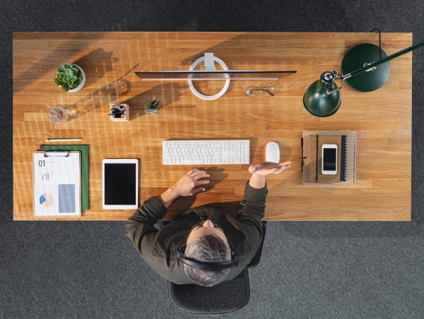 A top view of businessman working on computer at desk in home office, video call concept.