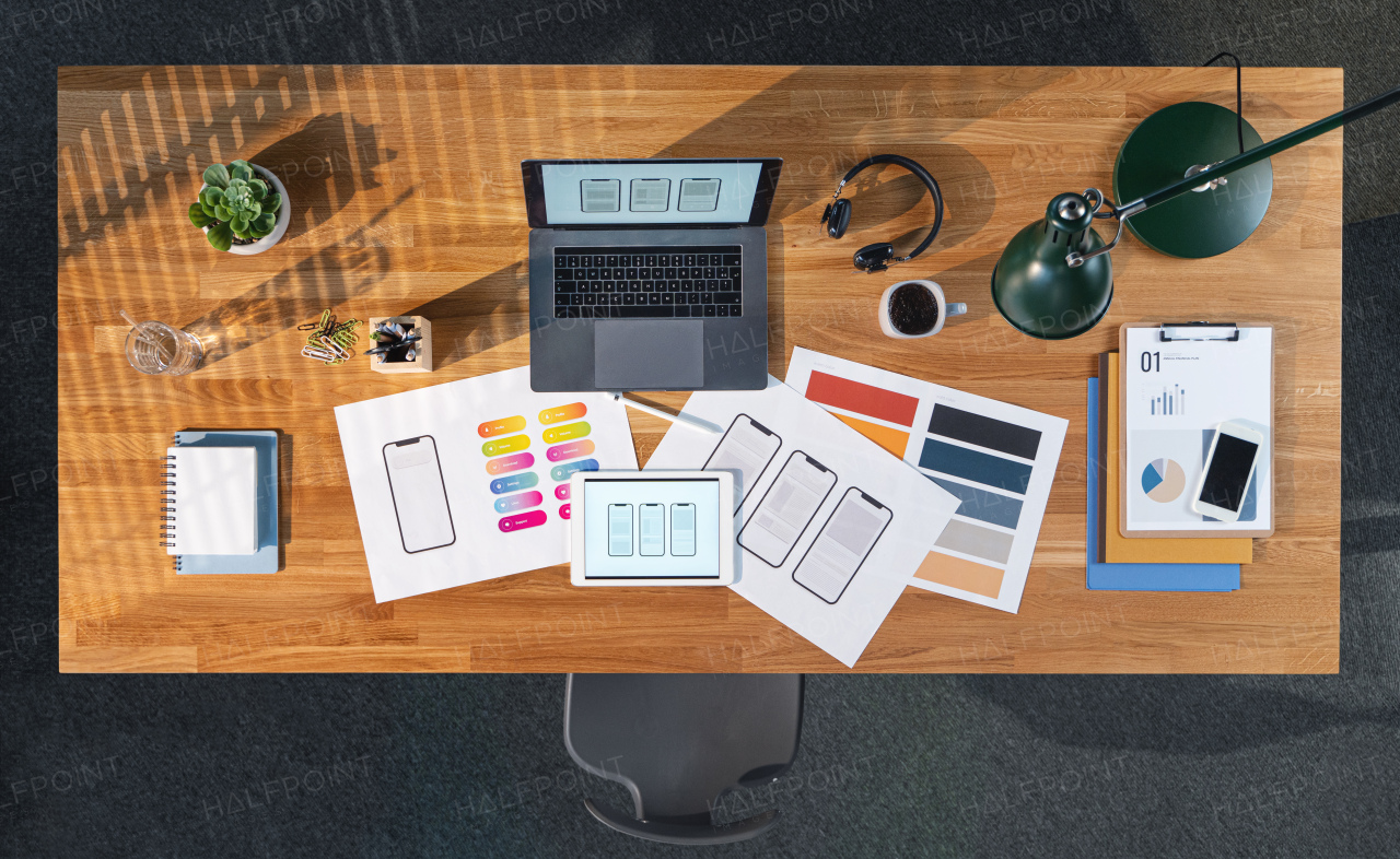 A top view of desk with computer, tablet and paperwork in home office. Creative business concept.