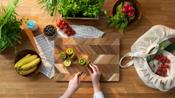 A top view of unrecognizable woman preparing fruit and vegetables, sustainable lifestyle.