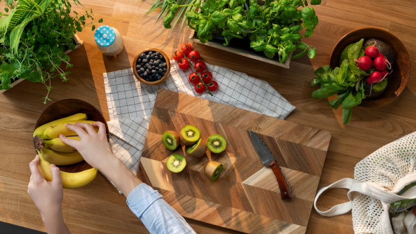 A top view of unrecognizable woman preparing fruit and vegetables, sustainable lifestyle.