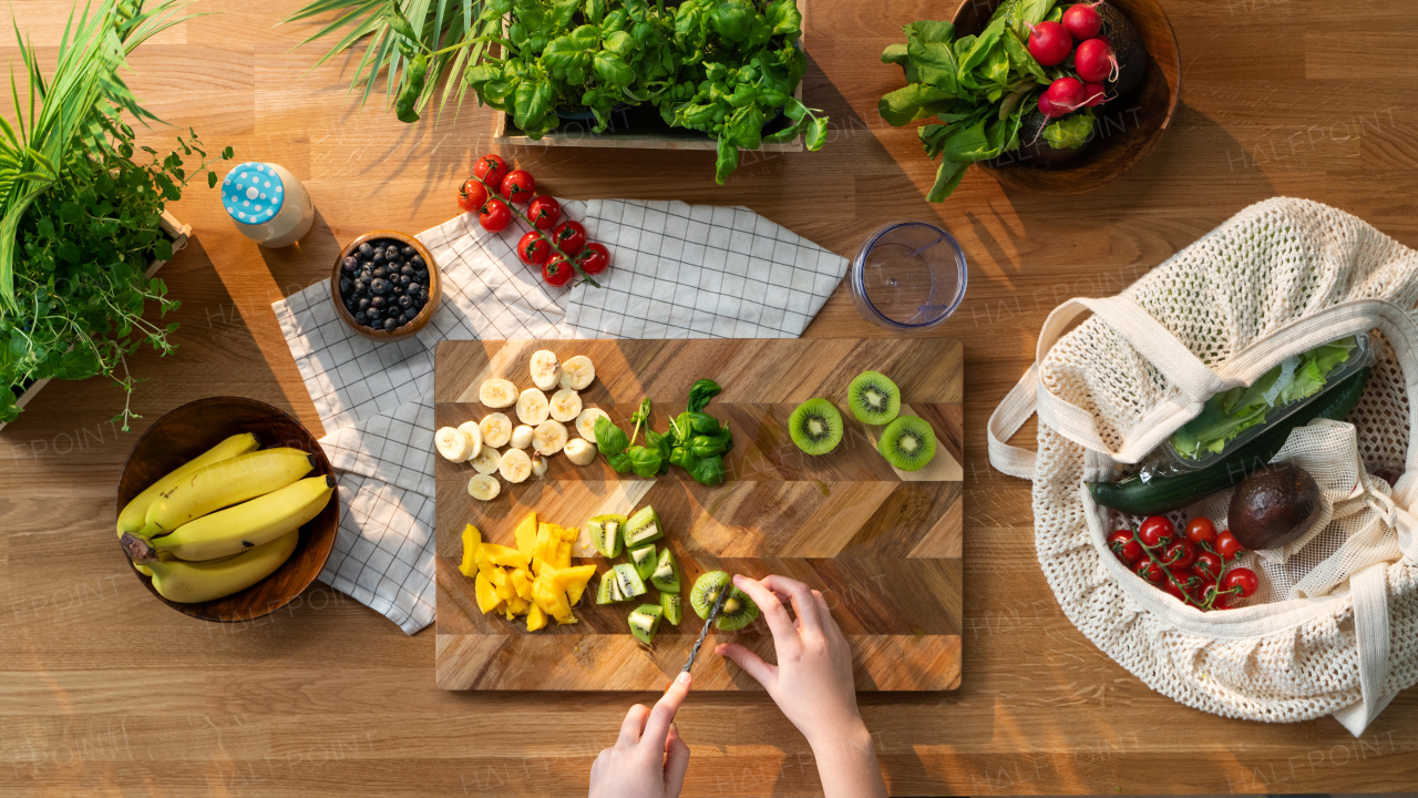 A top view of unrecognizable woman preparing fruit and vegetables, sustainable lifestyle.