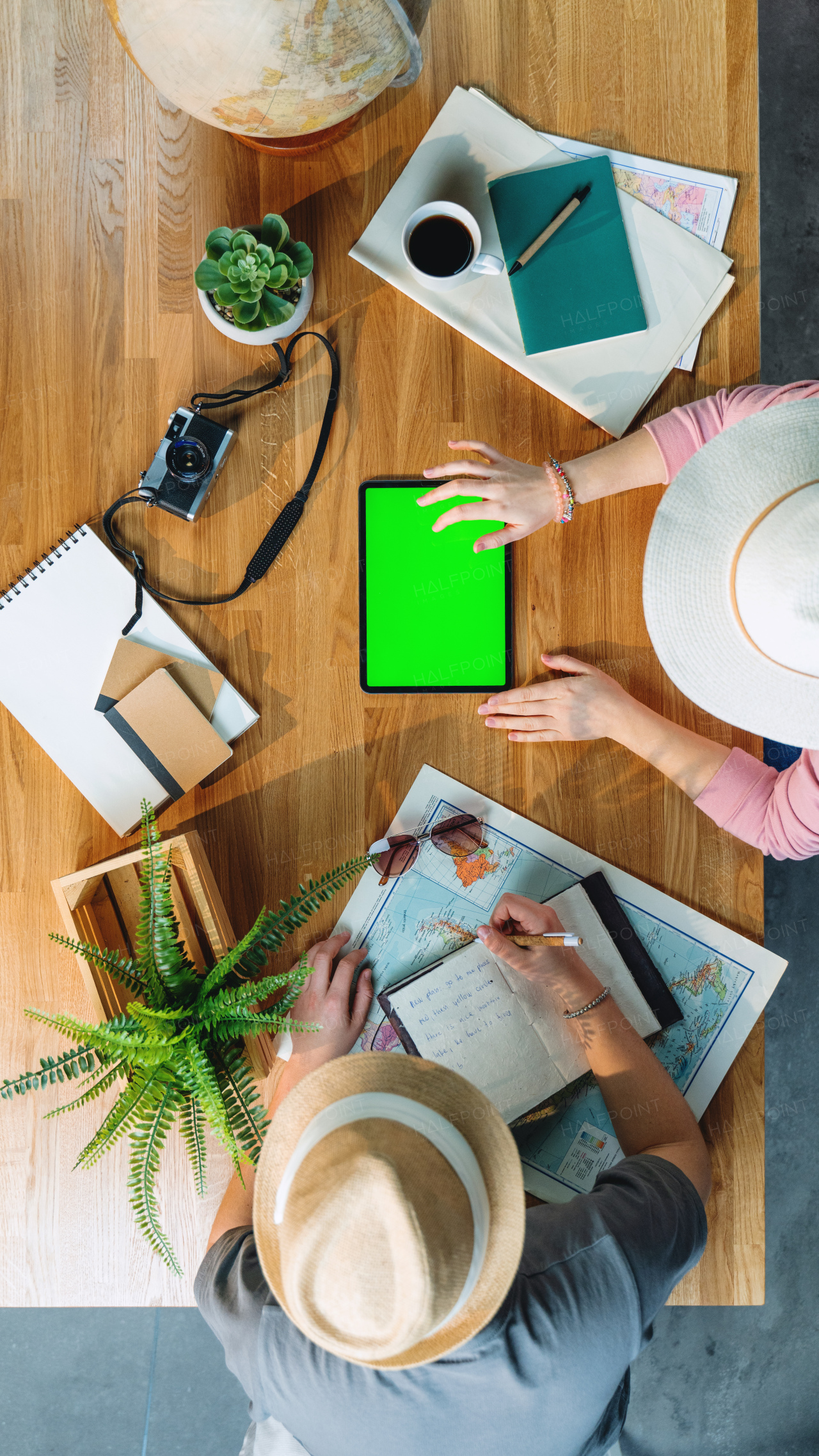 Top view of young couple with tablet planning vacation trip holiday, desktop travel and green screen.