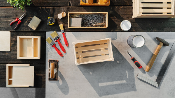 A top view of group of tools for making wooden boxes, small business and desktop concept.