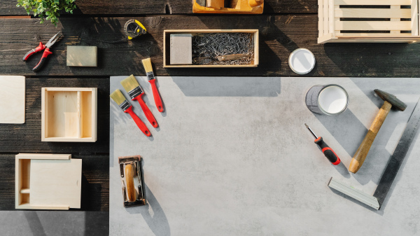 A top view of group of tools for making wooden boxes, small business and desktop concept.