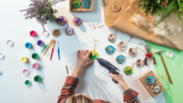 A top view of unrecognizable craftswoman making diy decorations, small business and desktop concept.