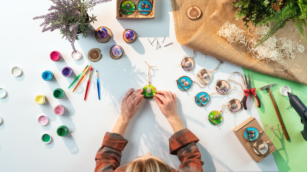 A top view of unrecognizable craftswoman making diy decorations, small business and desktop concept.