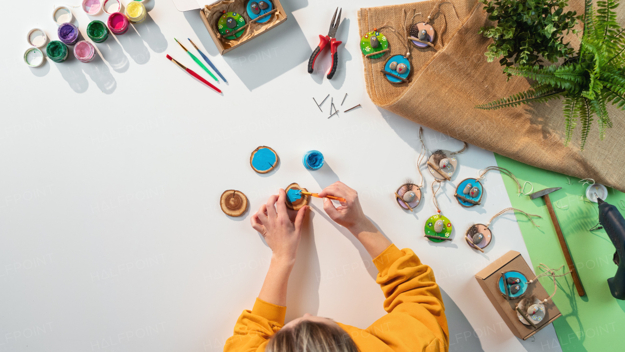 A top view of unrecognizable craftswoman making diy decorations, small business and desktop concept.