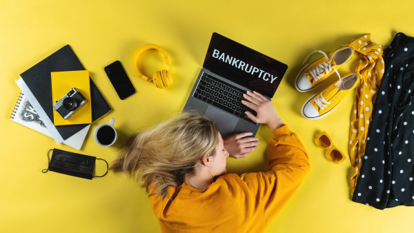 A top view of frustrated business woman at desk , coronavirus and bankruptcy desktop concept.