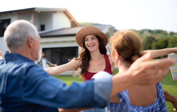 A portrait of happy people outdoors on family birthday party, greeting.