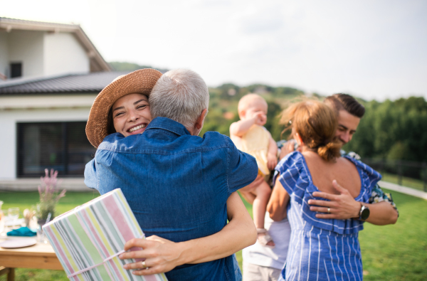 A portrait of happy people outdoors on family birthday party.