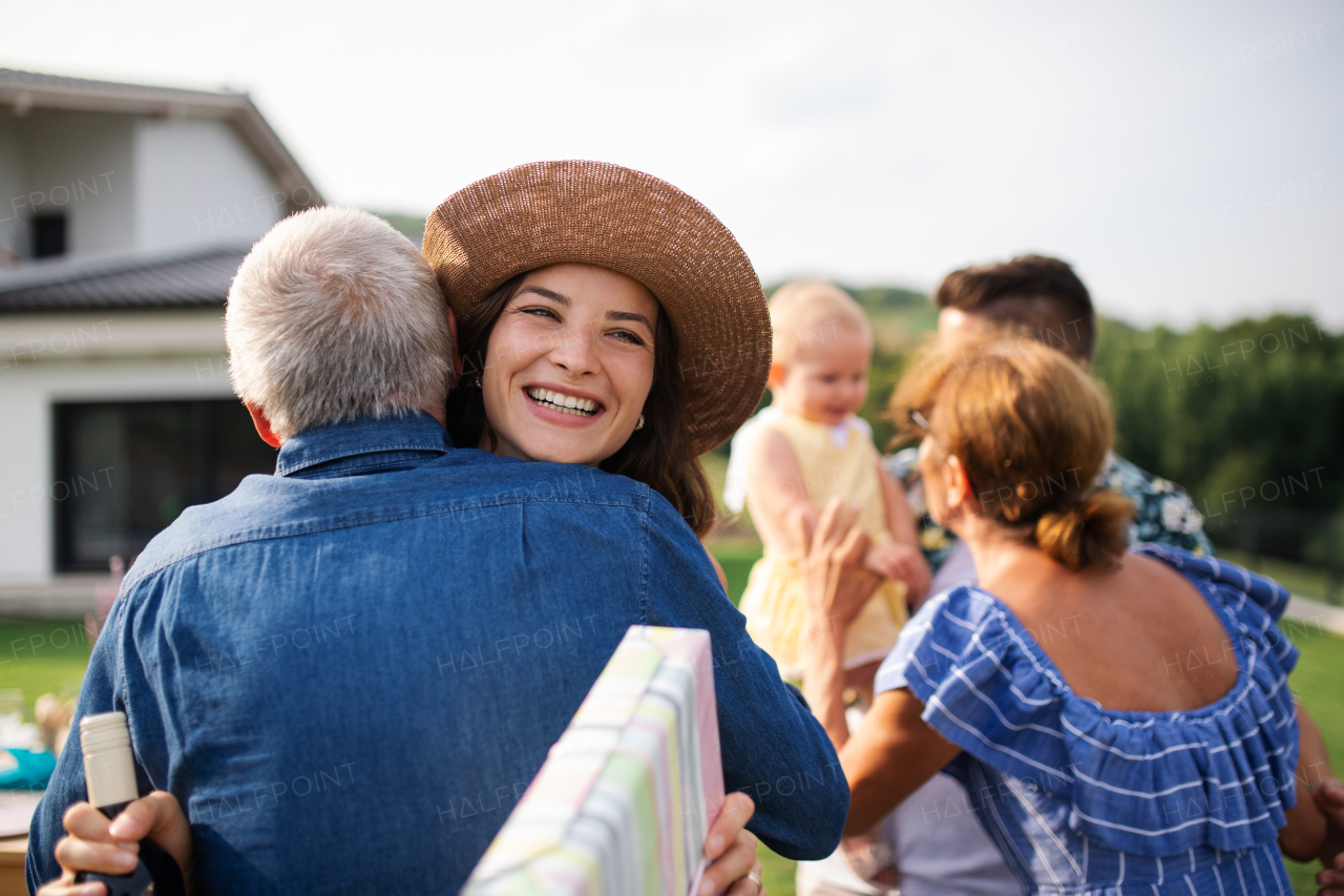 A portrait of happy people outdoors on family birthday party.