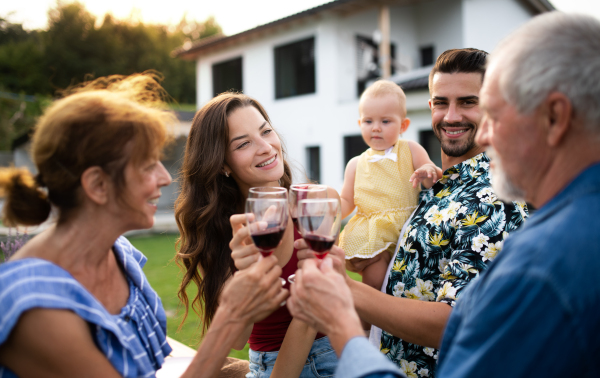 Portrait of people with wine outdoors on family garden barbecue, drinking wine.