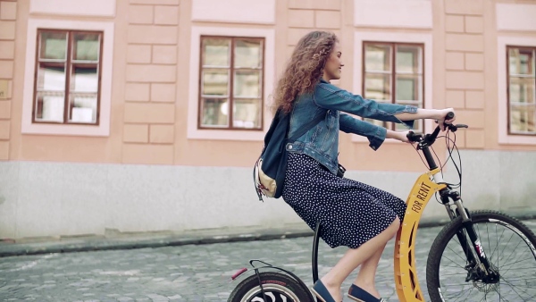 Young tourist couple travellers with electric scooters in small town, sightseeing. Slow motion.