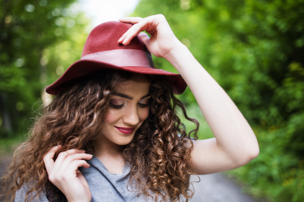 Close-up portrait of young woman traveller standing in nature. Copy space.