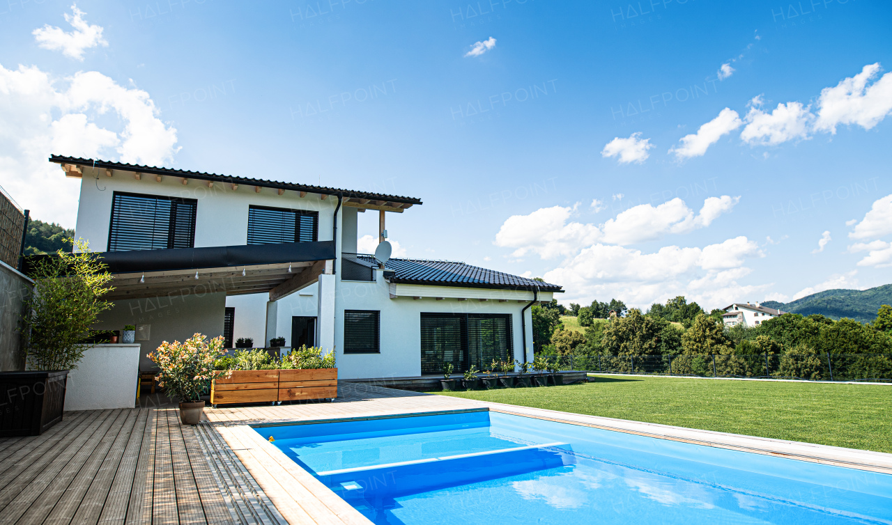 House with swimming pool outdoors in backyard garden in the countryside.