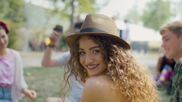 Front view of beautiful young girl at summer festival, looking at camera.