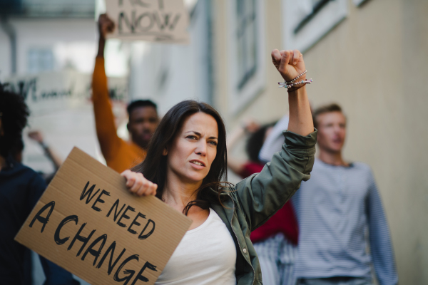 A group of people activists protesting on streets, strike and demonstration concept.