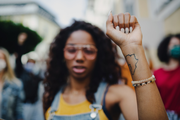 Portrait of african american woman activists protesting on streets, strike and demonstration concept.