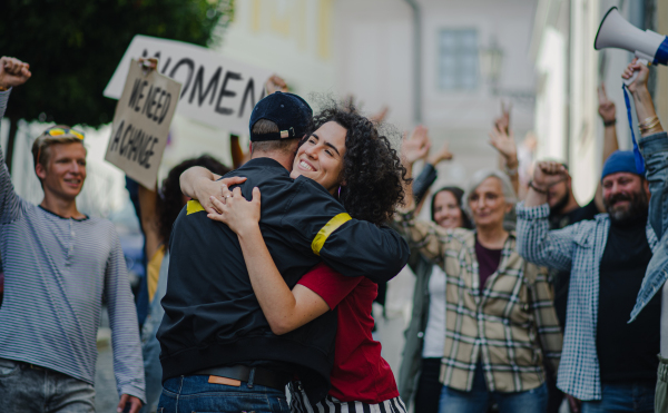 Police stopping group of people activists protesting on streets, a women march and demonstration concept.