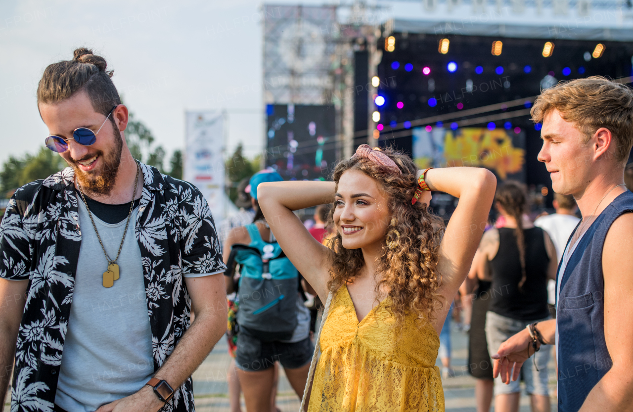 Group of cheerful young friends at summer festival.