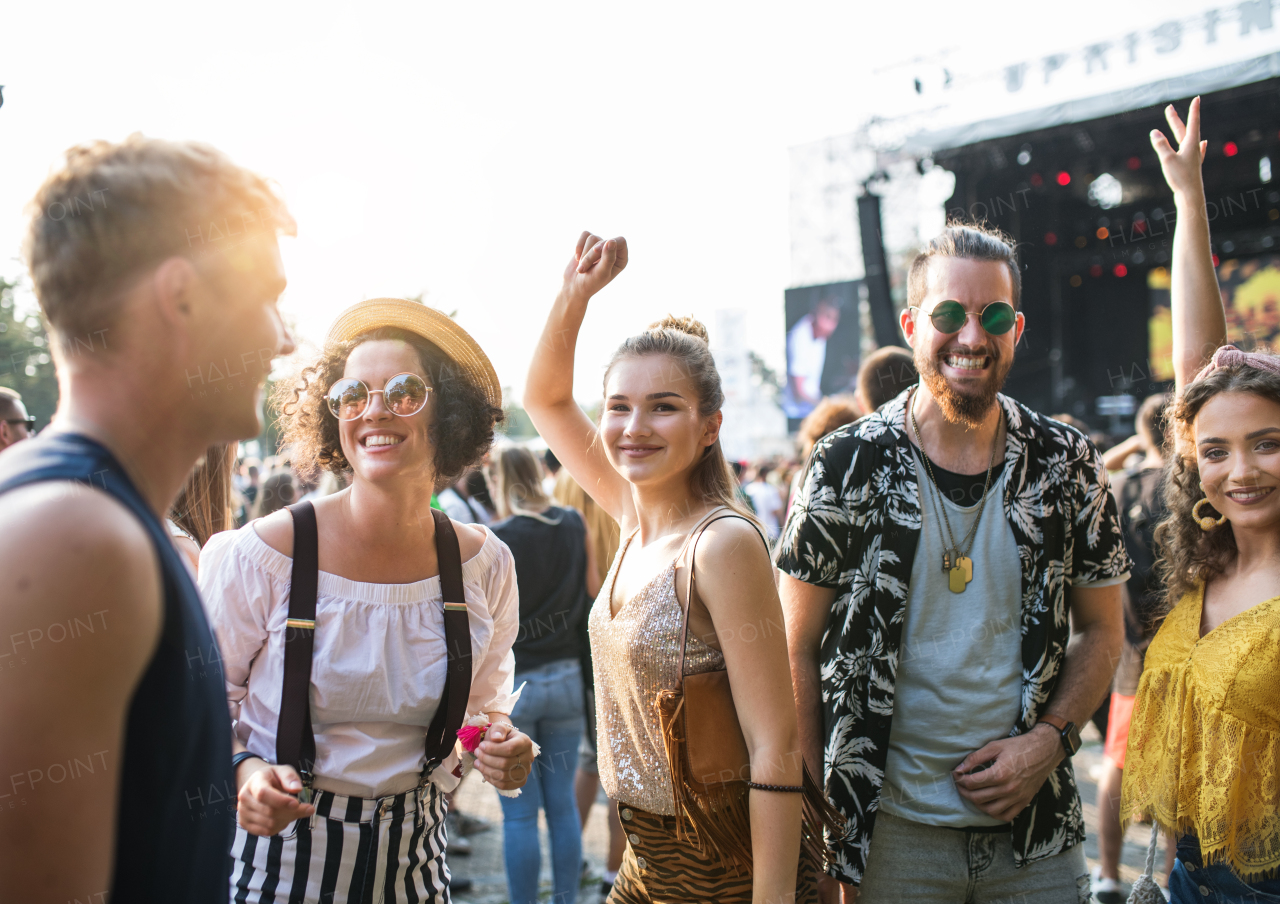 A front view portrait of group of young friends dancing at summer festival.