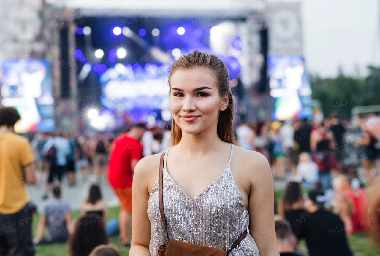 A beautiful young woman standing at summer festival.