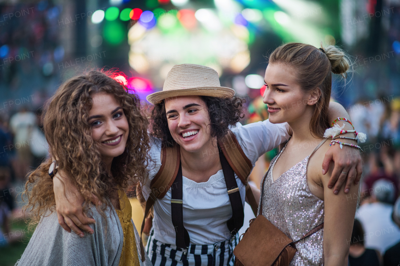 A front view of group of young female friends standing at summer festival.