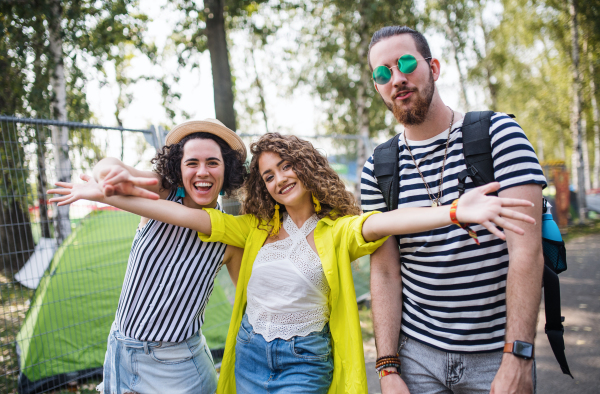 A group of young people at summer festival, looking at camera.