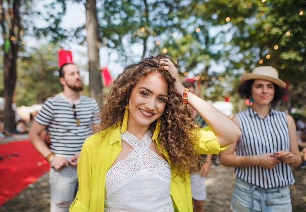 A front view of beautiful young woman at summer festival