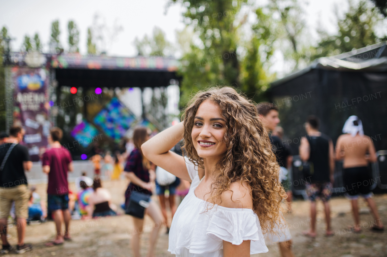 A young woman at summer festival, looking at camera.