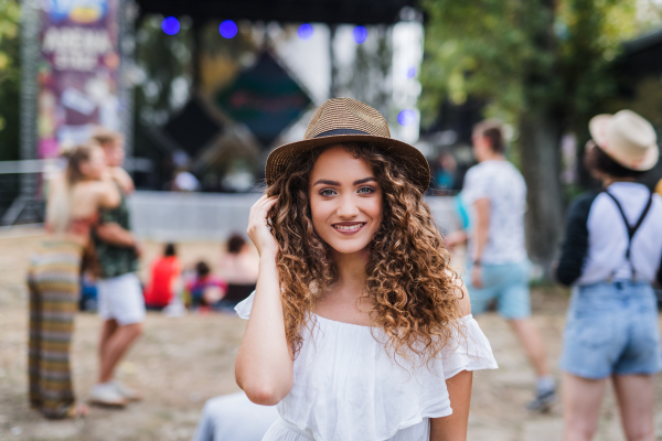 Front view of beautiful young girl at summer festival, looking at camera.