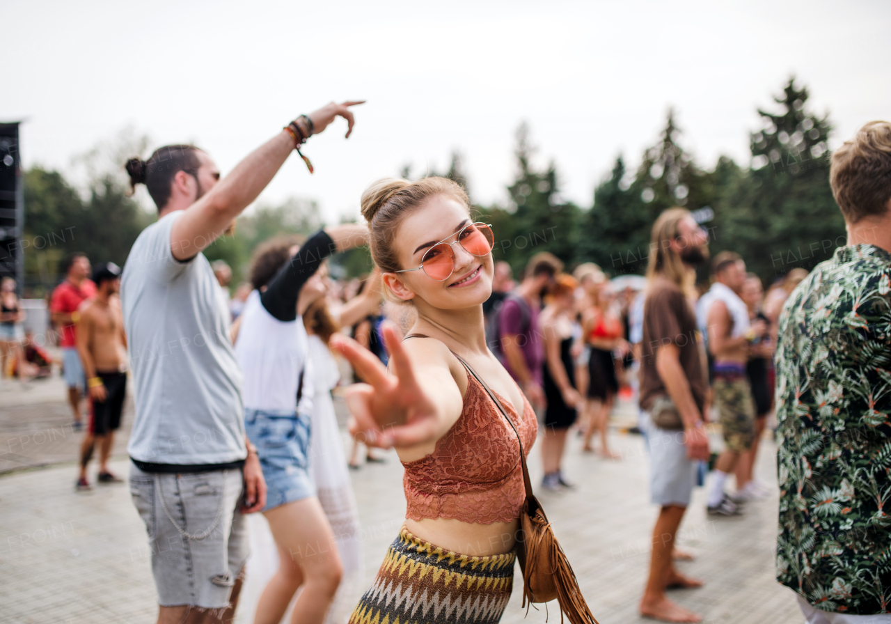 A beautiful young woman dancing at summer festival.