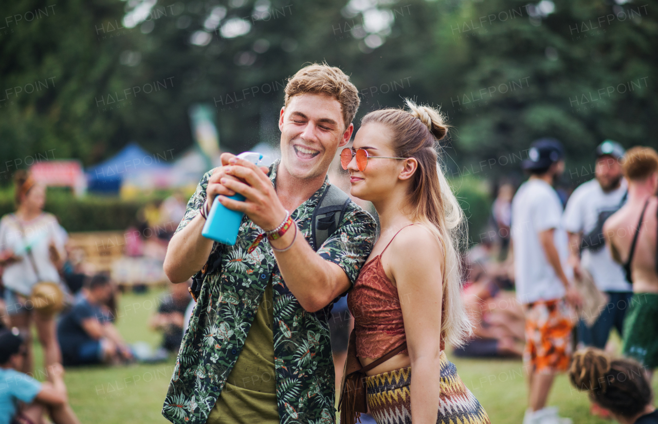 A young couple at summer festival, having fun.