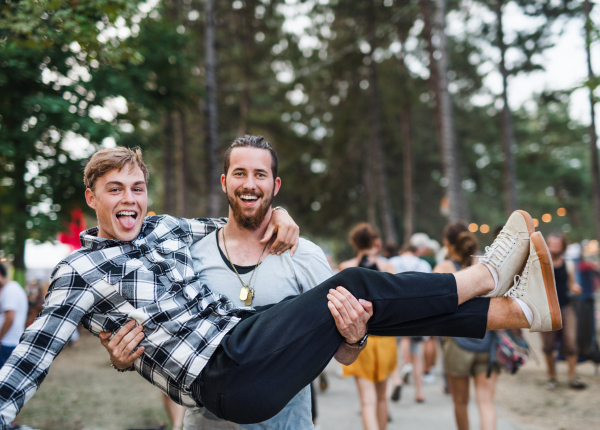 Front view of young boy friends at summer festival, having fun.