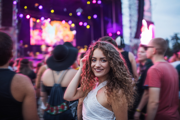 Beautiful young woman at summer festival, looking at camera. Copy space.