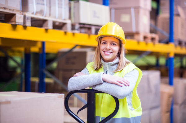 Portrait of a young woman warehouse worker or a supervisor.