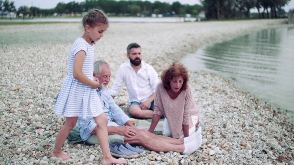 Multigeneration family on a holiday by the lake, resting and relaxing.