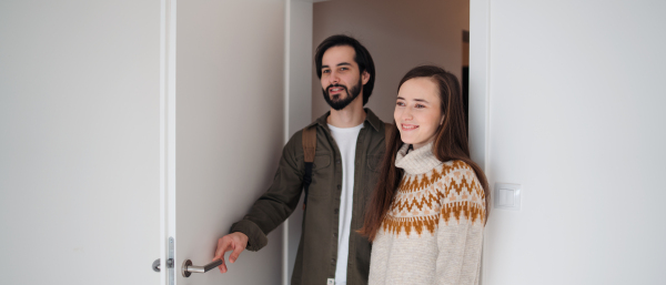 Happy young couple moving in new flat, new home and relocation concept.