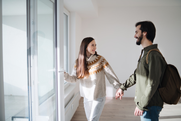 Happy young couple moving in new flat, new home and relocation concept.