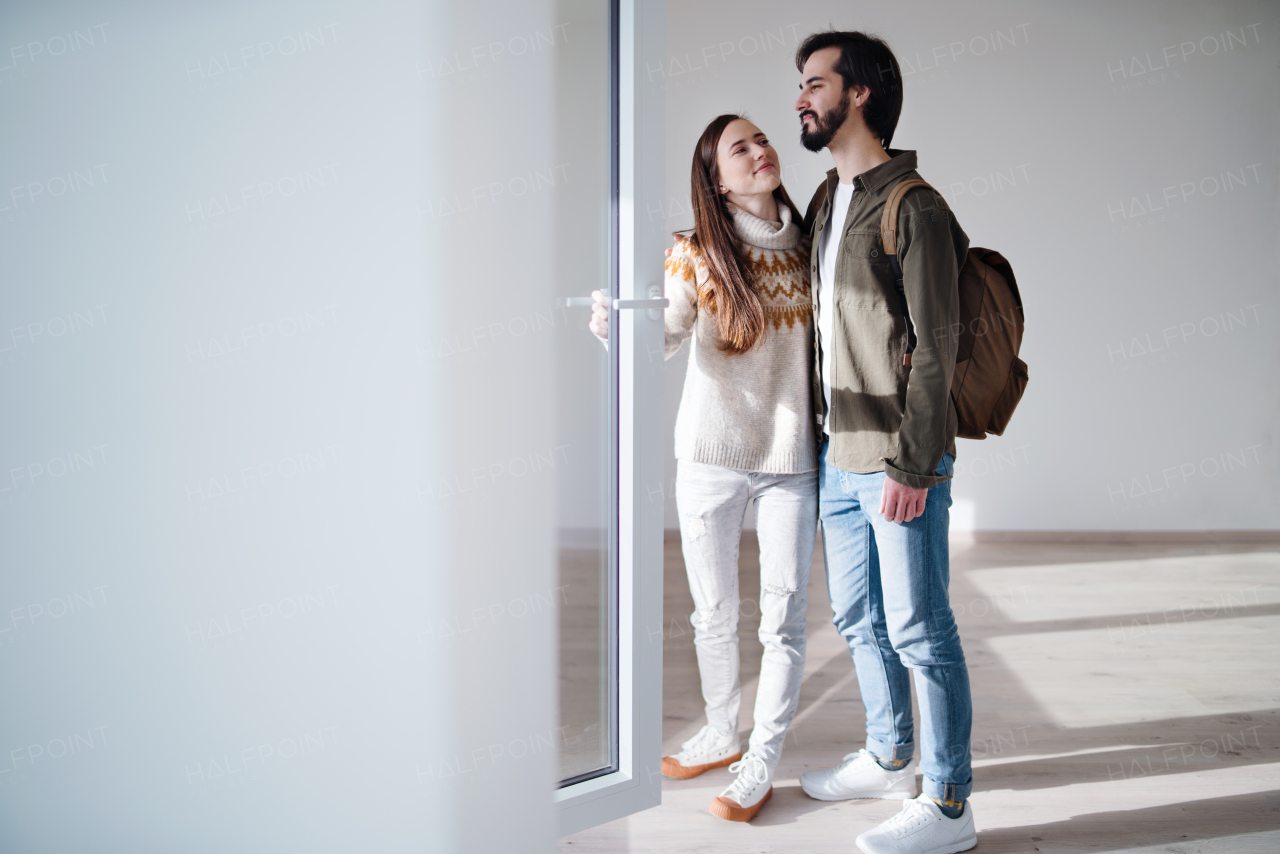 Happy young couple moving in new flat, new home and relocation concept.